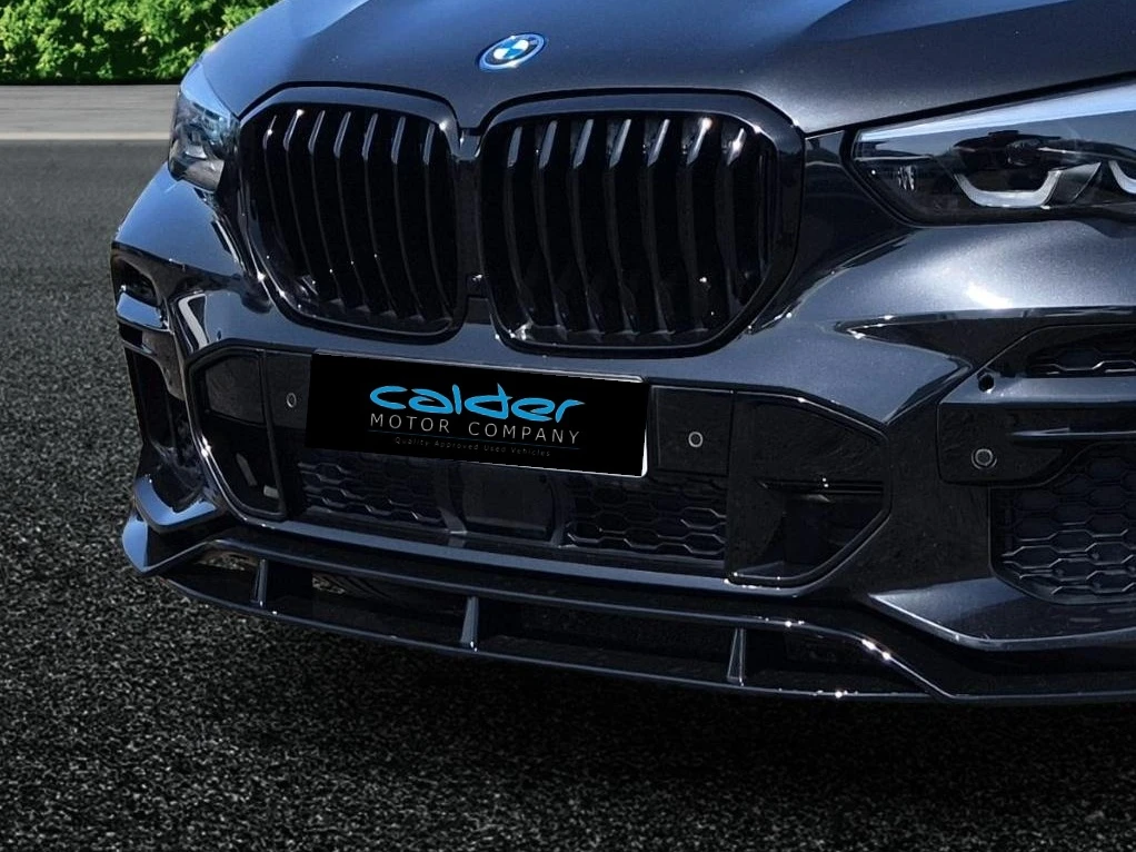 A dealer's car photographed against a Motuva studio background — with a corner banner drawn to scale